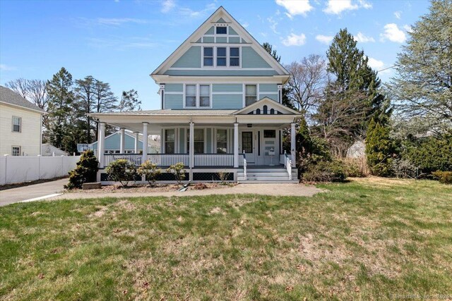 289 Gulf St, Milford, CT 06460 - view of front of home with a porch, fence, and a front lawn