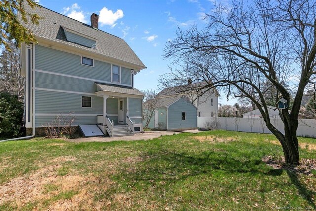 289 Gulf St, Milford, CT 06460 - back of property with fence, a lawn, and a chimney