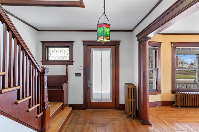 289 Gulf St, Milford, CT 06460 - foyer with crown molding, radiator heating unit, baseboards, and stairs