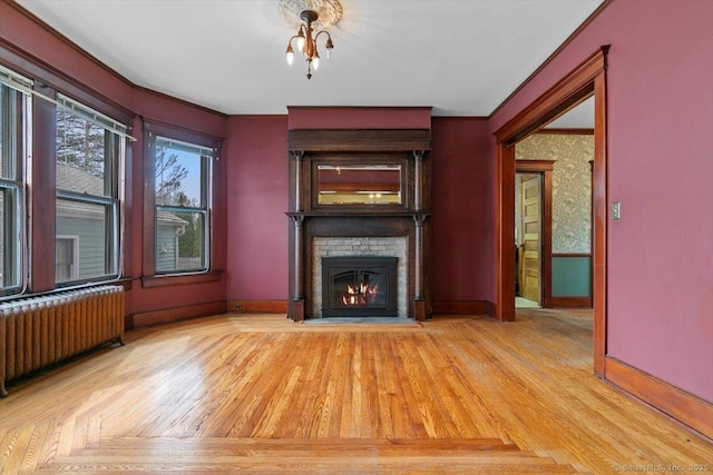 289 Gulf St, Milford, CT 06460 - unfurnished living room with radiator, wood finished floors, baseboards, and a brick fireplace