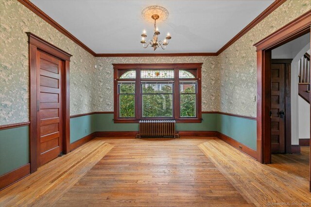 289 Gulf St, Milford, CT 06460 - empty room featuring baseboards, a chandelier, crown molding, radiator, and hardwood / wood-style flooring