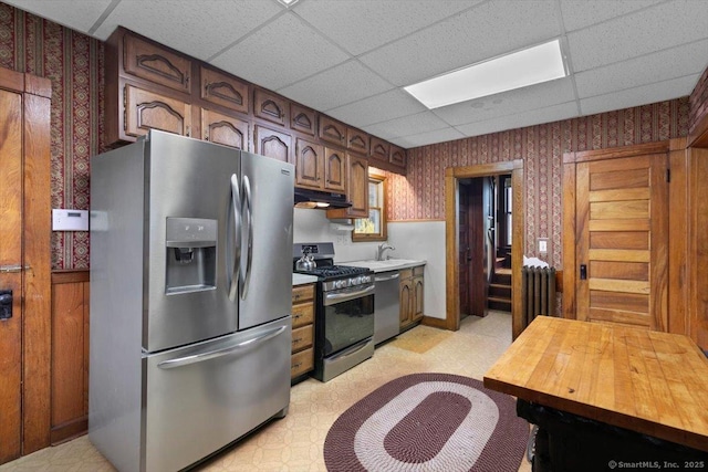289 Gulf St, Milford, CT 06460 - kitchen with wallpapered walls, radiator heating unit, light floors, and stainless steel appliances