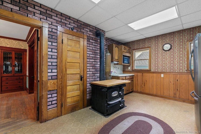 289 Gulf St, Milford, CT 06460 - kitchen featuring a wood stove, freestanding refrigerator, a drop ceiling, and built in microwave