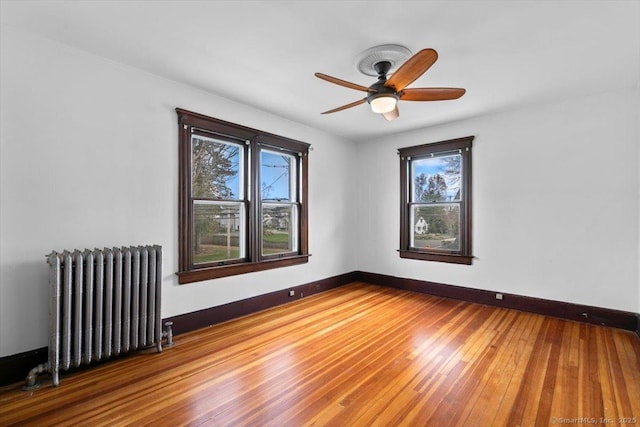289 Gulf St, Milford, CT 06460 - empty room with wood finished floors, radiator heating unit, baseboards, and a ceiling fan