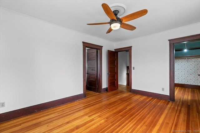 289 Gulf St, Milford, CT 06460 - unfurnished bedroom featuring ornamental molding, baseboards, a ceiling fan, and wood finished floors
