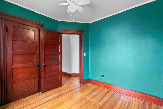 289 Gulf St, Milford, CT 06460 - unfurnished bedroom featuring ornamental molding, baseboards, and light wood-type flooring