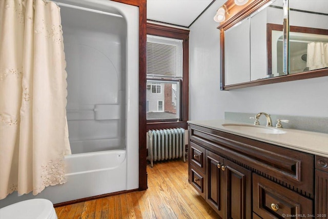 289 Gulf St, Milford, CT 06460 - bathroom with vanity, shower / tub combo with curtain, toilet, radiator, and wood finished floors