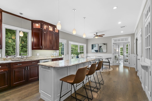 10 Applegate Ln, Monroe, CT 06468 - kitchen featuring dark wood-type flooring, glass insert cabinets, ceiling fan, a kitchen island, and a breakfast bar area