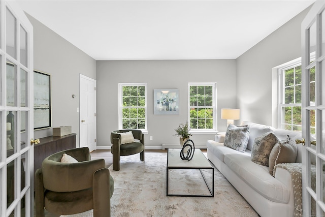 10 Applegate Ln, Monroe, CT 06468 - living area with healthy amount of natural light, french doors, and a baseboard heating unit
