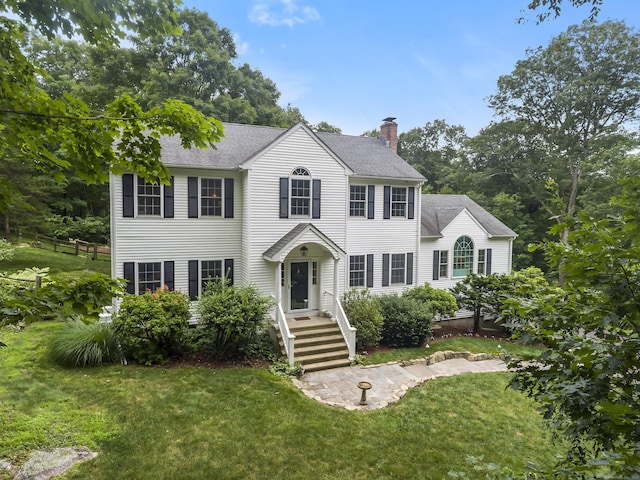 10 Applegate Ln, Monroe, CT 06468 - colonial inspired home with a chimney, a front yard, and roof with shingles