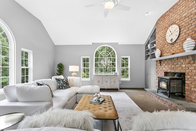 10 Applegate Ln, Monroe, CT 06468 - living room featuring wood finished floors, a wood stove, a ceiling fan, high vaulted ceiling, and built in shelves