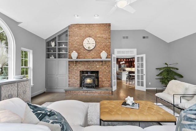 10 Applegate Ln, Monroe, CT 06468 - living area featuring vaulted ceiling, a wood stove, built in shelves, wood finished floors, and ceiling fan