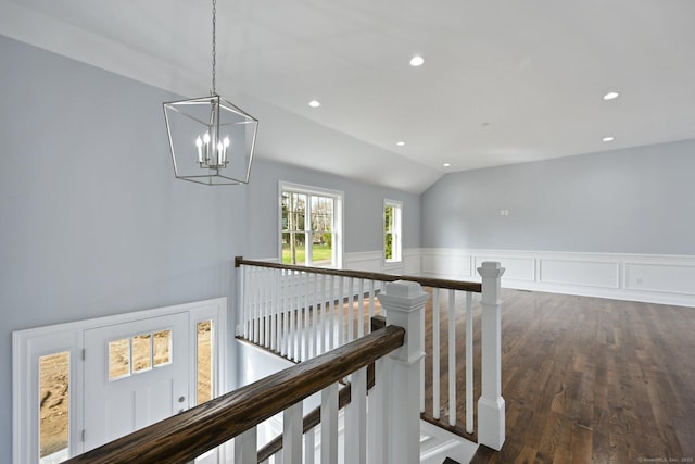 01 Sunrise Rd, Danbury, CT 06811 - hallway with an upstairs landing, a chandelier, vaulted ceiling, wainscoting, and dark wood-style floors