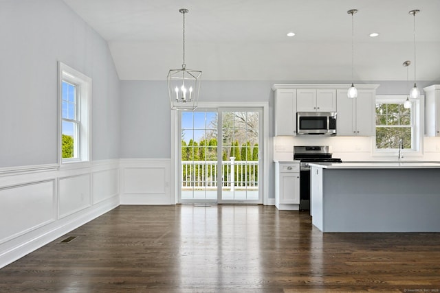 01 Sunrise Rd, Danbury, CT 06811 - kitchen with appliances with stainless steel finishes, lofted ceiling, a chandelier, wainscoting, and light countertops