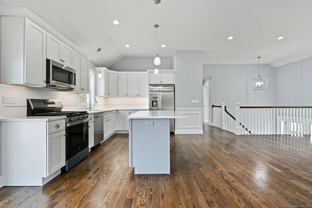 01 Sunrise Rd, Danbury, CT 06811 - kitchen featuring appliances with stainless steel finishes, vaulted ceiling, dark wood finished floors, a kitchen island, and light countertops