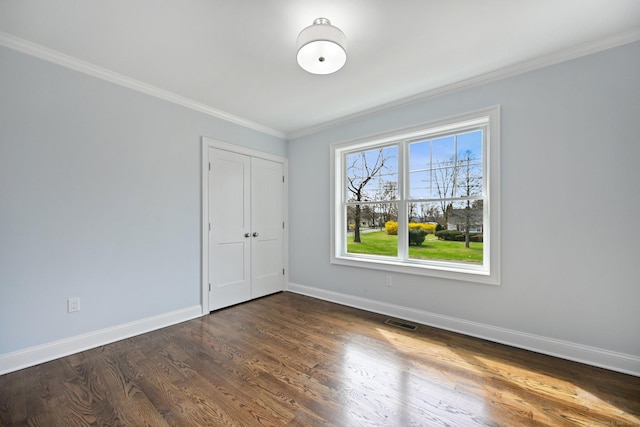 01 Sunrise Rd, Danbury, CT 06811 - unfurnished bedroom featuring ornamental molding, dark wood-style flooring, and a closet
