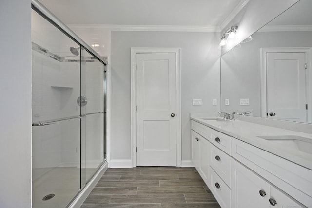 01 Sunrise Rd, Danbury, CT 06811 - bathroom with double vanity, a stall shower, wood finished floors, and ornamental molding