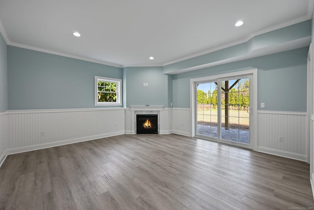 01 Sunrise Rd, Danbury, CT 06811 - unfurnished living room featuring a wainscoted wall, wood finished floors, ornamental molding, a lit fireplace, and recessed lighting