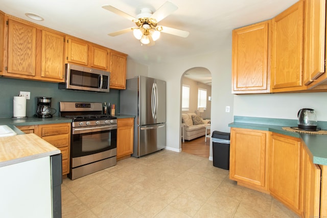 102 Broadway, Milford, CT 06460 - kitchen with arched walkways, ceiling fan, and stainless steel appliances