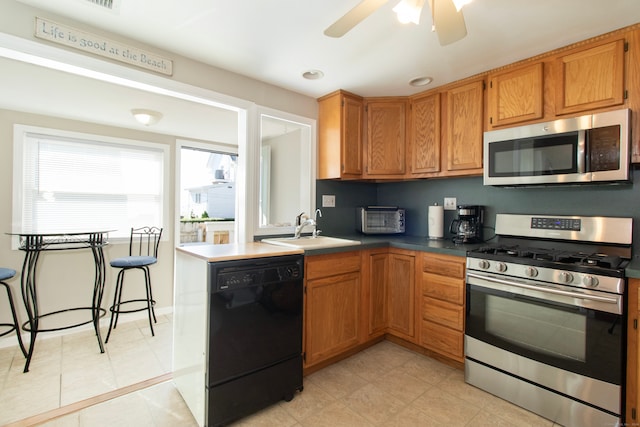 102 Broadway, Milford, CT 06460 - kitchen with brown cabinets, appliances with stainless steel finishes, a sink, a ceiling fan, and recessed lighting