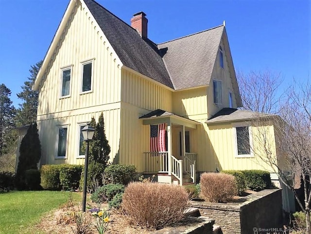7 Beacon Ln, Norfolk, CT 06058 - view of front of home featuring a front lawn, board and batten siding, a chimney, and a shingled roof