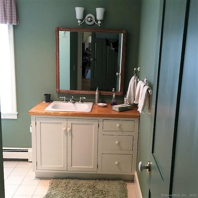 7 Beacon Ln, Norfolk, CT 06058 - bathroom with tile patterned floors, vanity, baseboard heating, and a healthy amount of sunlight