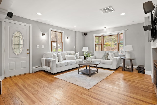 living room with recessed lighting, visible vents, light wood finished floors, and a baseboard radiator
