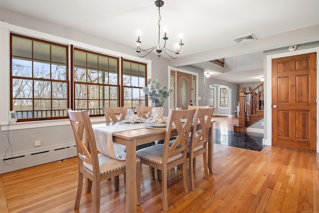 dining room with a notable chandelier, light wood-style floors, stairs, baseboards, and a baseboard radiator