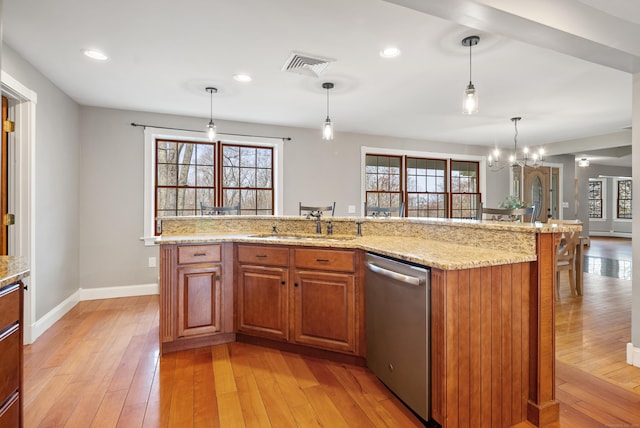 kitchen with stainless steel dishwasher, visible vents, baseboards, plenty of natural light, and light wood-type flooring