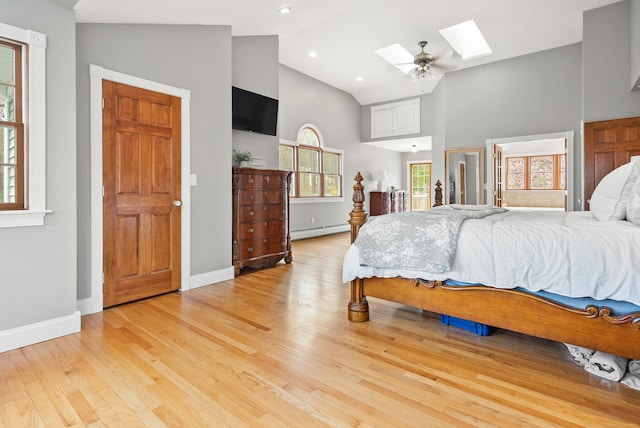 bedroom featuring baseboards, high vaulted ceiling, light wood-type flooring, a baseboard radiator, and a skylight