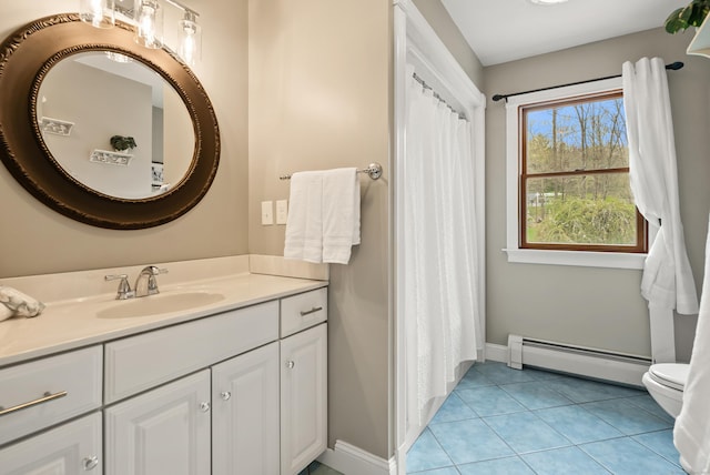 bathroom featuring tile patterned flooring, vanity, toilet, baseboards, and a baseboard radiator