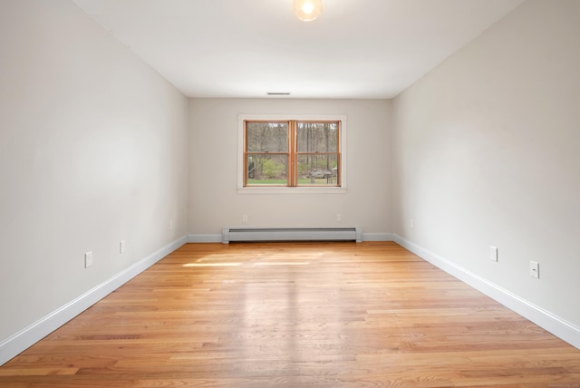 unfurnished room with light wood-type flooring, baseboards, and baseboard heating