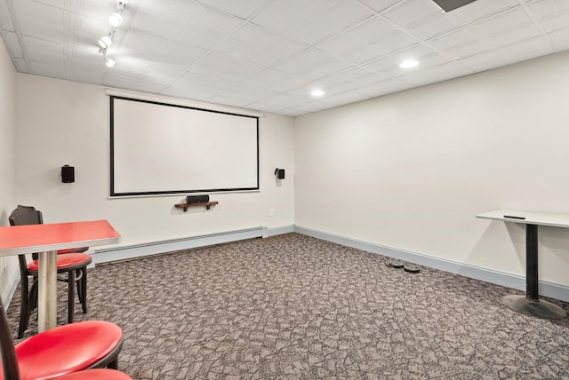 carpeted cinema room featuring recessed lighting, baseboards, a baseboard radiator, and rail lighting