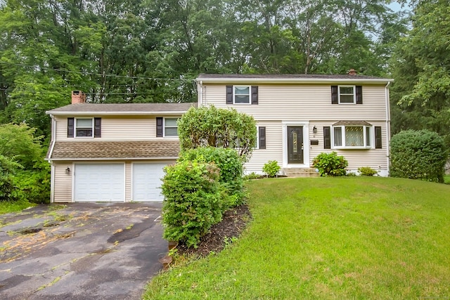 10 Belinda Ln, Enfield, CT 06082 - colonial inspired home featuring a chimney, an attached garage, driveway, a front yard, and view of scattered trees