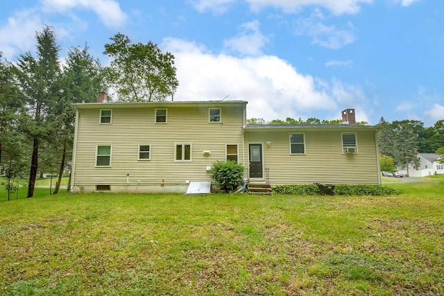 10 Belinda Ln, Enfield, CT 06082 - rear view of house featuring a chimney, entry steps, and a lawn