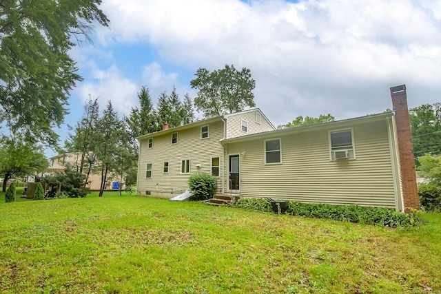10 Belinda Ln, Enfield, CT 06082 - back of house with a chimney, a yard, entry steps, and cooling unit