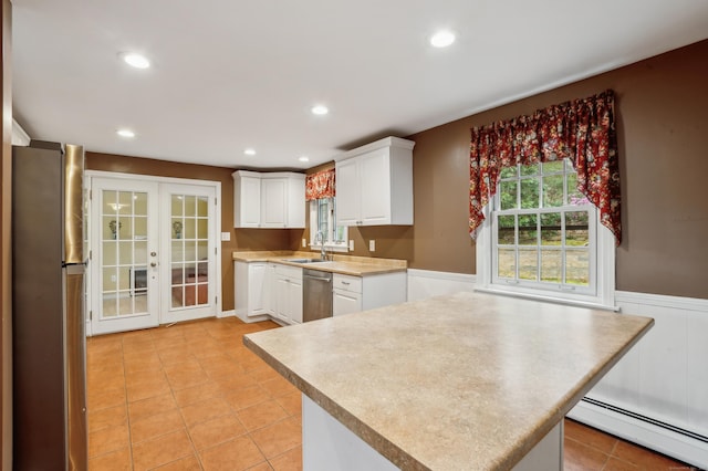 17 Fernwood Ln, Somers, CT 06071 - kitchen featuring white cabinets, appliances with stainless steel finishes, a baseboard radiator, a wainscoted wall, and light countertops