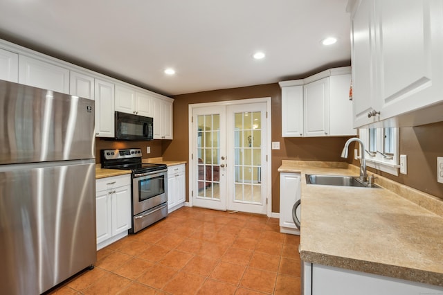 17 Fernwood Ln, Somers, CT 06071 - kitchen with recessed lighting, appliances with stainless steel finishes, a sink, white cabinetry, and french doors
