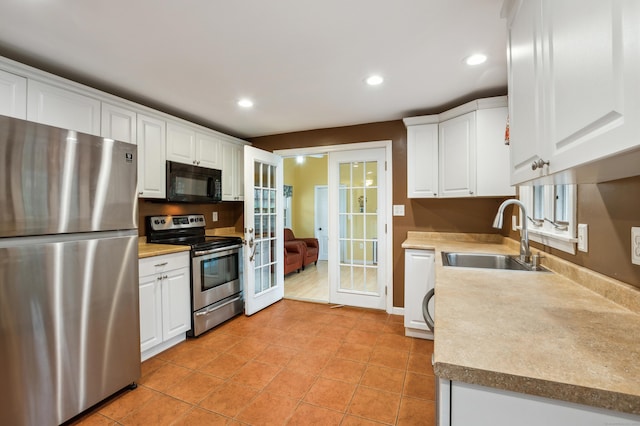 17 Fernwood Ln, Somers, CT 06071 - kitchen featuring french doors, stainless steel appliances, white cabinetry, and a sink