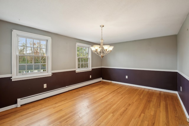 17 Fernwood Ln, Somers, CT 06071 - spare room with an inviting chandelier, baseboard heating, wood finished floors, and baseboards