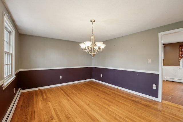 17 Fernwood Ln, Somers, CT 06071 - empty room featuring an inviting chandelier, baseboards, wood finished floors, and a baseboard radiator