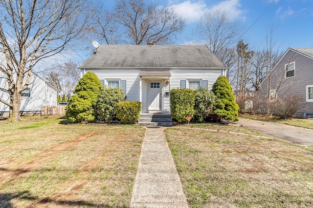 view of front of house with a front yard and fence