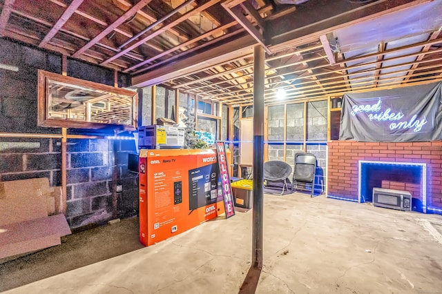 unfinished basement featuring concrete block wall