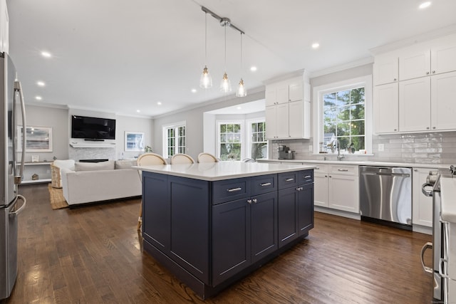 52 Morningside Dr, Greenwich, CT 06830 - kitchen featuring stainless steel appliances, open floor plan, ornamental molding, white cabinetry, and decorative backsplash
