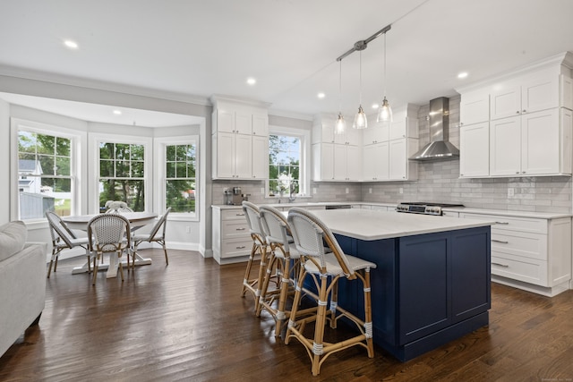 52 Morningside Dr, Greenwich, CT 06830 - kitchen featuring wall chimney range hood, light countertops, recessed lighting, a kitchen island, and white cabinetry