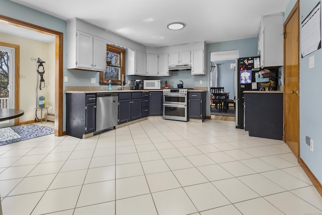 87 Summit St, Newington, CT 06111 - kitchen featuring light tile patterned floors, light countertops, under cabinet range hood, a healthy amount of sunlight, and appliances with stainless steel finishes