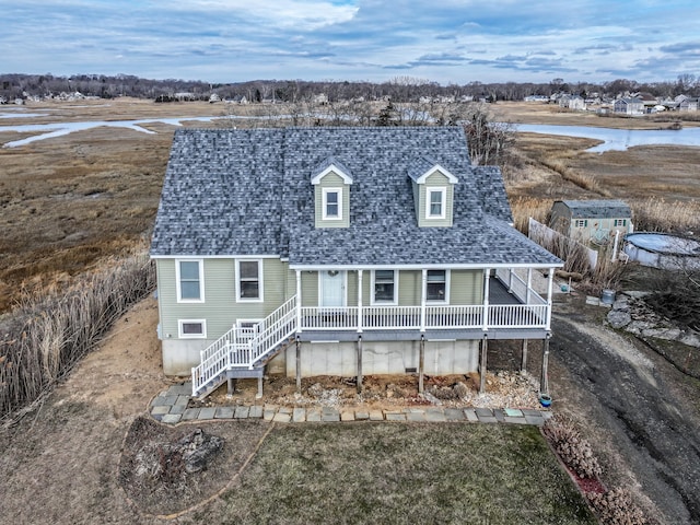 rear view of property with roof with shingles
