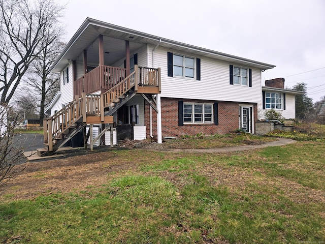 257 Main St, East Windsor, CT 06088 - exterior space with stairway, a front lawn, and brick siding