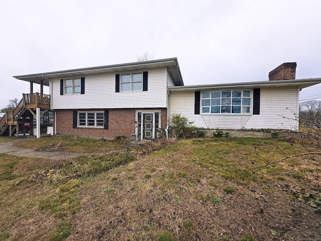 257 Main St, East Windsor, CT 06088 - tri-level home with stairs, brick siding, and a chimney
