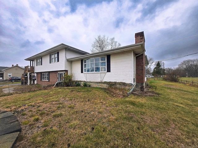 257 Main St, East Windsor, CT 06088 - split level home featuring a chimney, brick siding, and a front yard